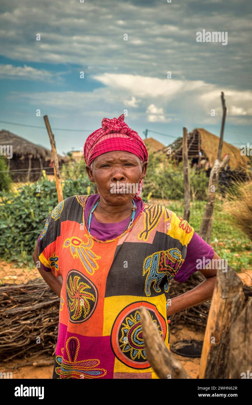 old African standing  in the outdoor kitchen in an African village Stock Photo