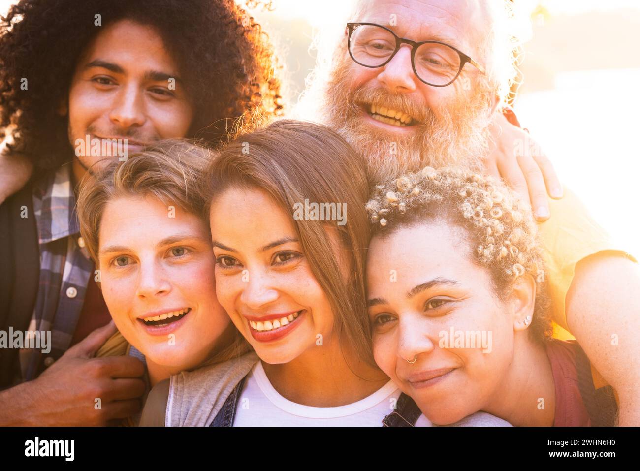 Young multiracial group of friends of different genders and ages having fun and taking a selfie with smartphone and having fun i Stock Photo
