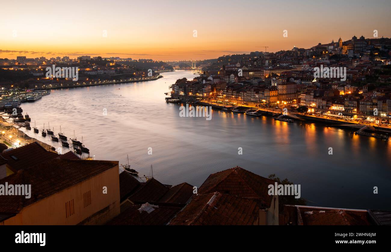 Cityscape of porto Portugal from Ponte de dom luis bridge at sunset. Douro river crossing the city Stock Photo