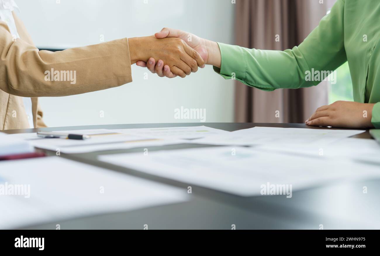 Business People shaking hands with unrecognizable colleague during ...
