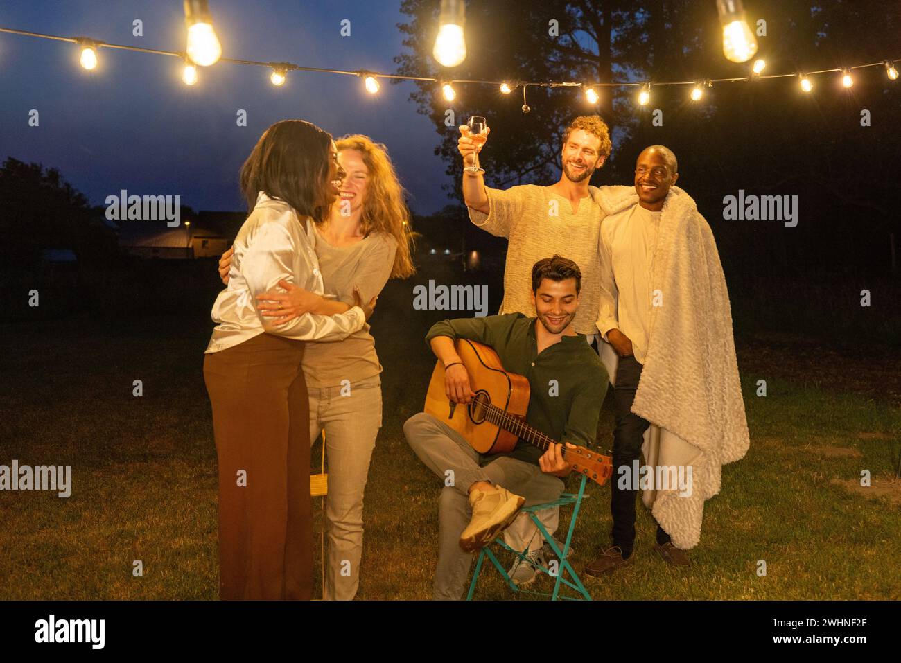 Inclusive Celebration: LGBTQ plus Friends Dancing Around the Campfire Stock Photo