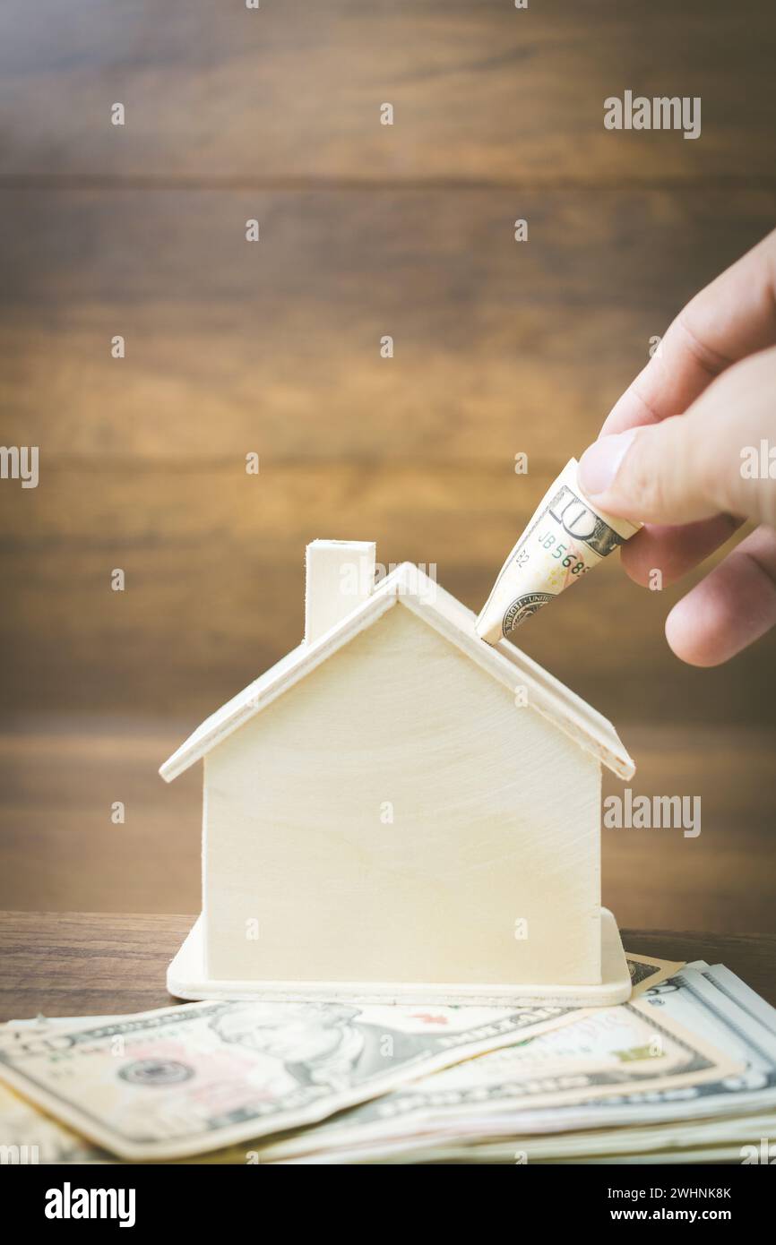 Money and house model on wooden background , Finance and banking concept. Stock Photo