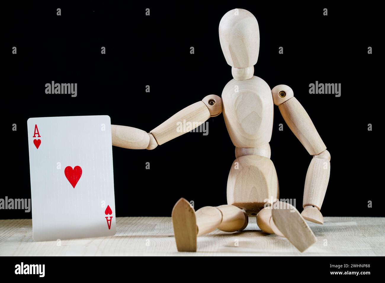 Wooden dummy and ace poker card hearts, game concept, puppet made of ...