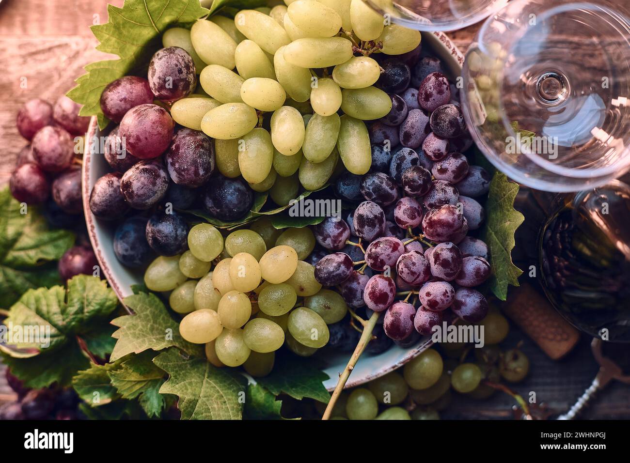 Grapes in a bowl on wooden table Stock Photo