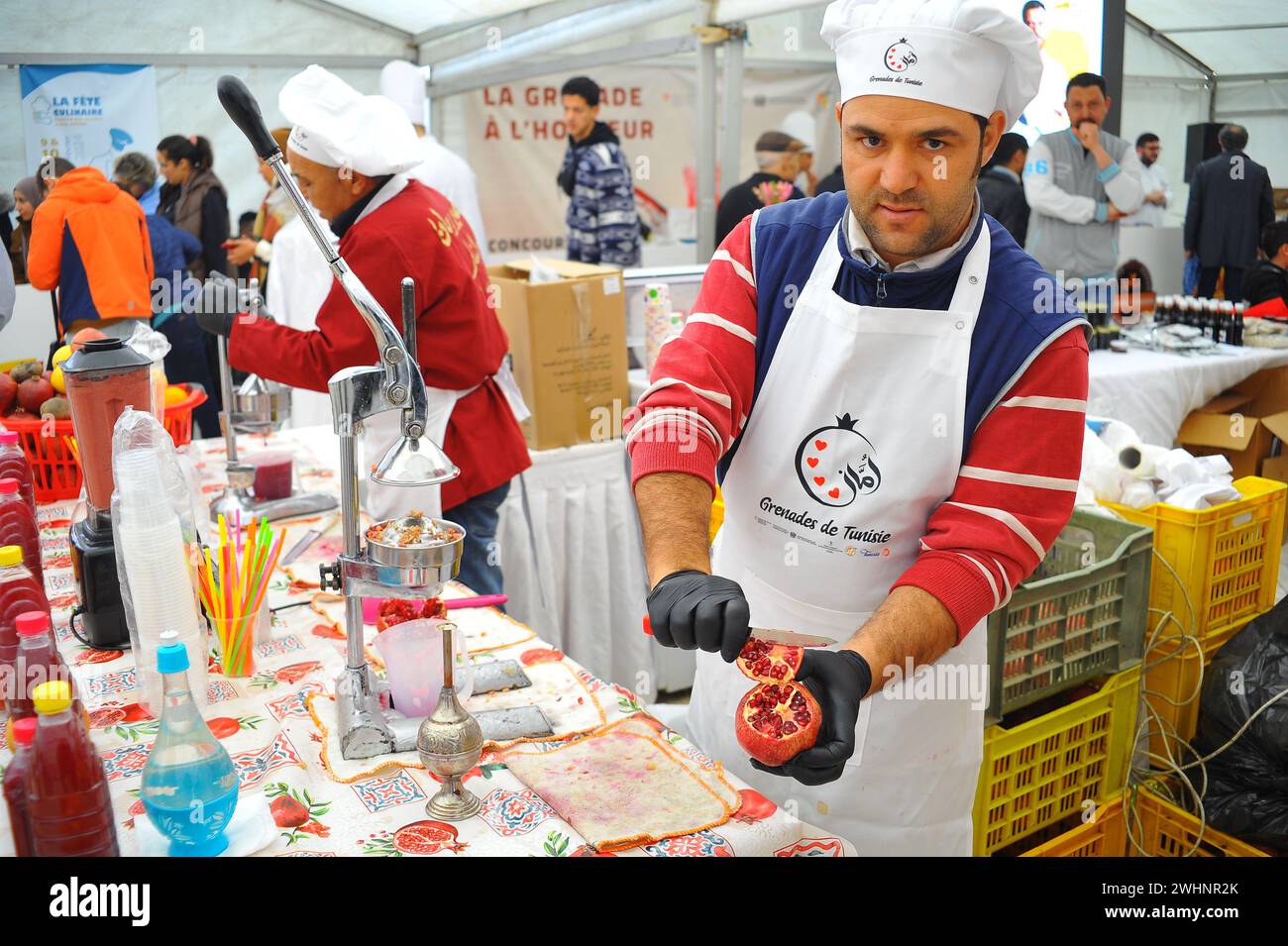 Tunis. 10th Feb, 2024. Workers prepare pomegranate juice at a food exhibition in Tunis, Tunisia on Feb. 10, 2024. Credit: Adel Ezzine/Xinhua/Alamy Live News Stock Photo