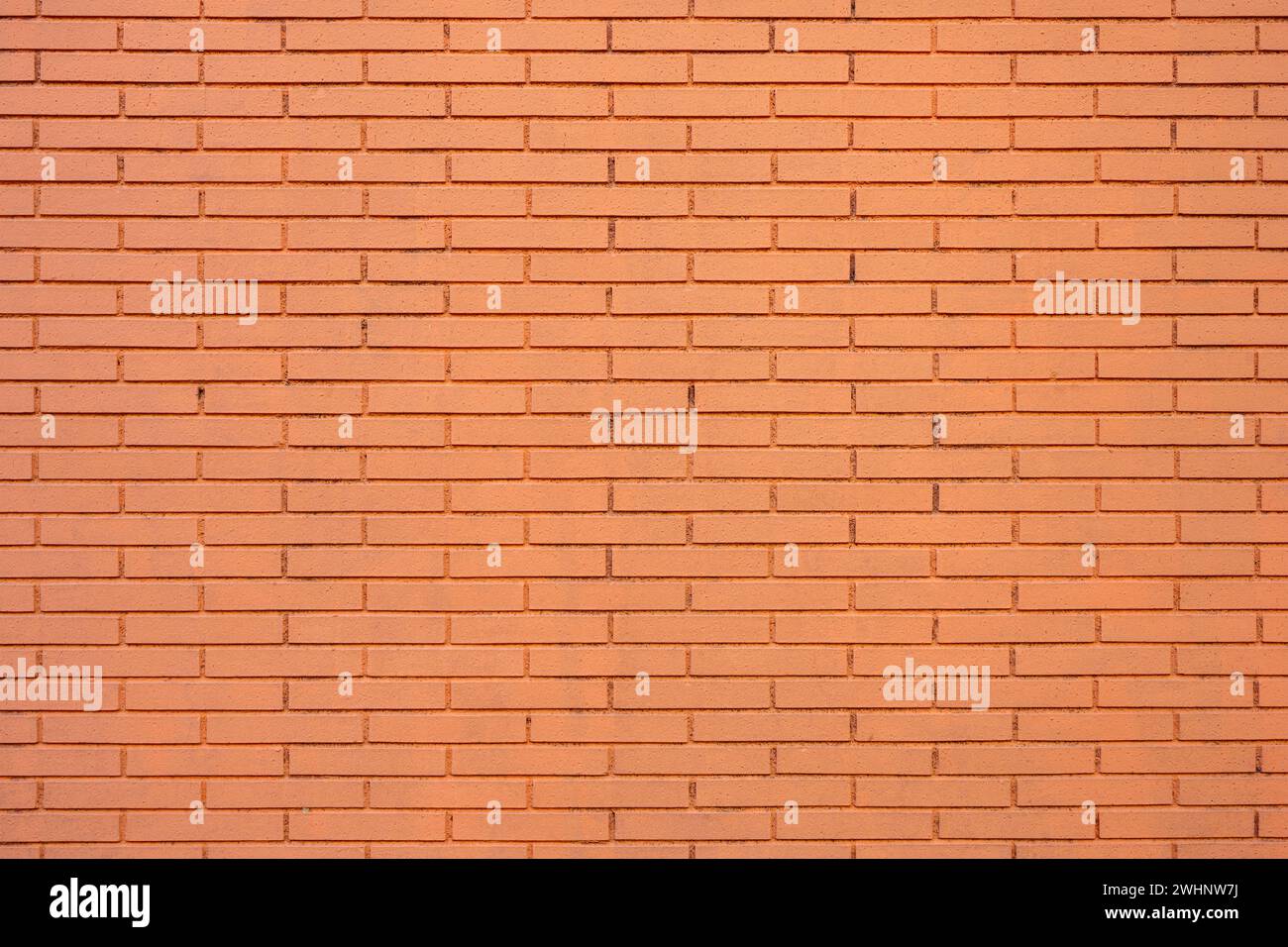 Background from a wall made of orange painted bricks Stock Photo
