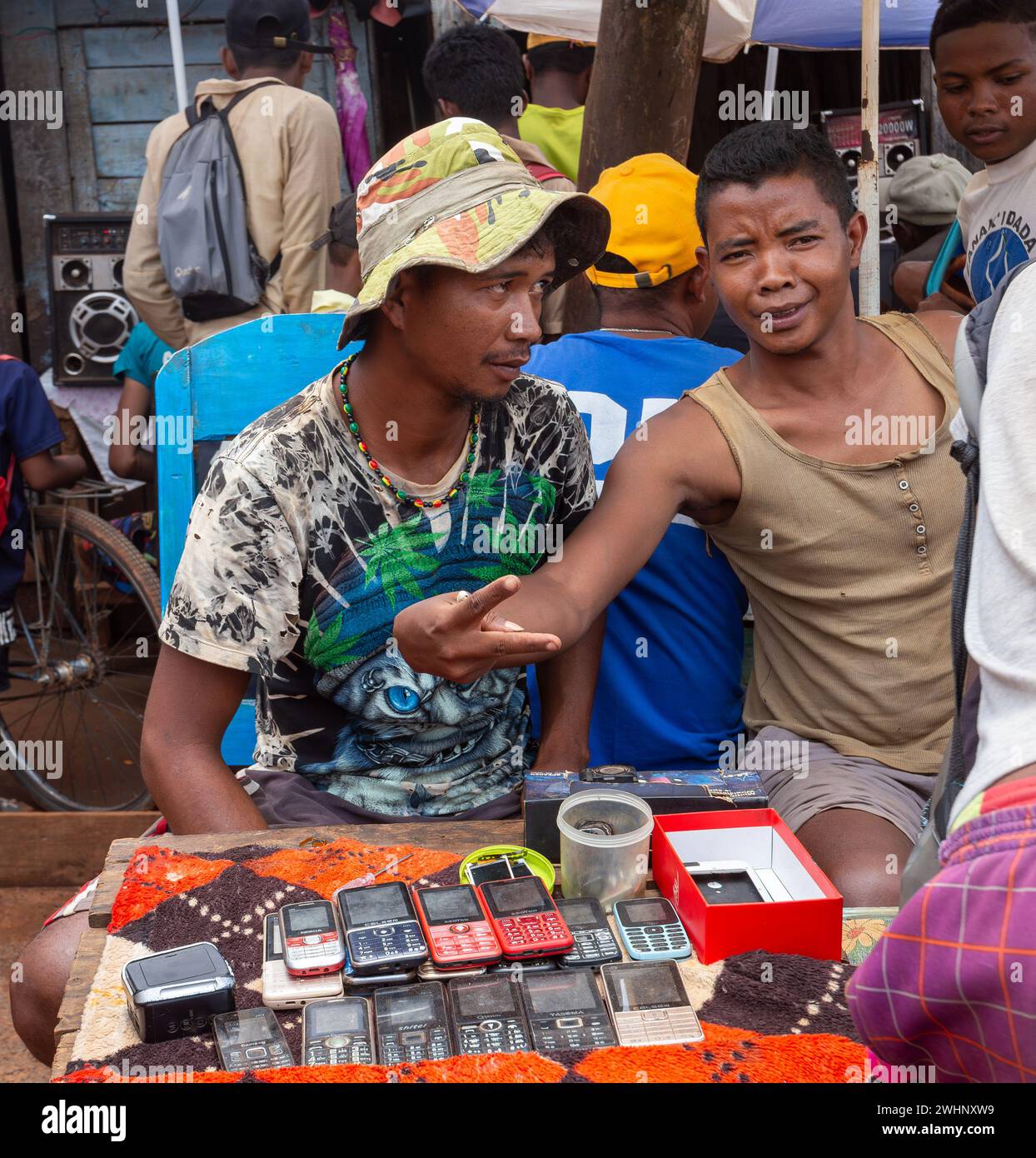 Malagasy man sell old fashioned cellular mobile phones on the street. Mandoto, Madagascar Stock Photo