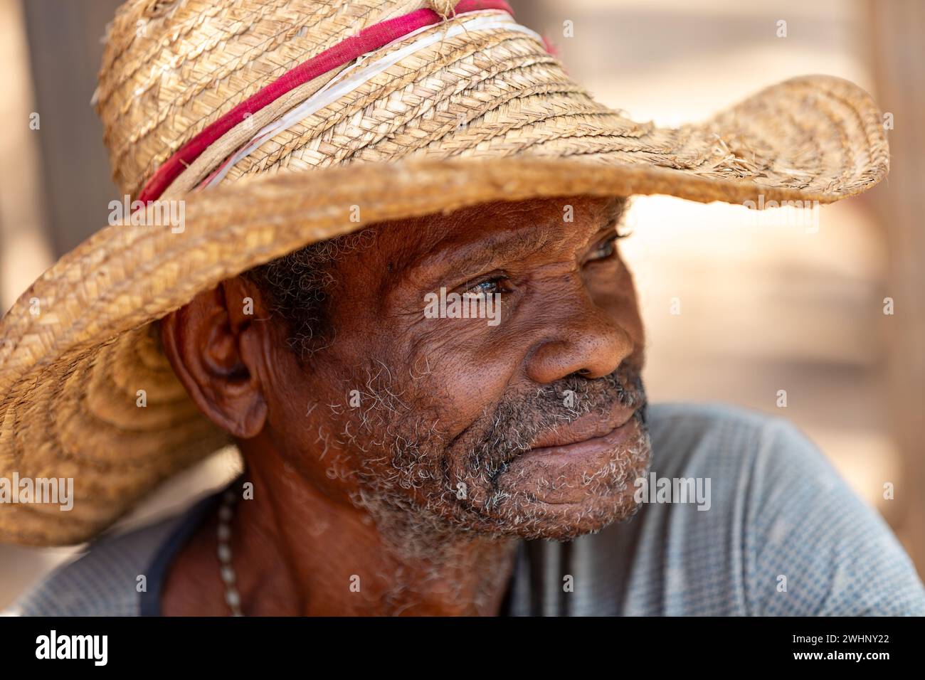 Elderly man wearing a straw hat and smiling. Miandrivazo, Madagascar Stock Photo