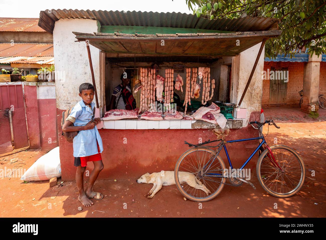 Woman buys meat from a street butchery in Mandoto, Madagascar. Stock Photo