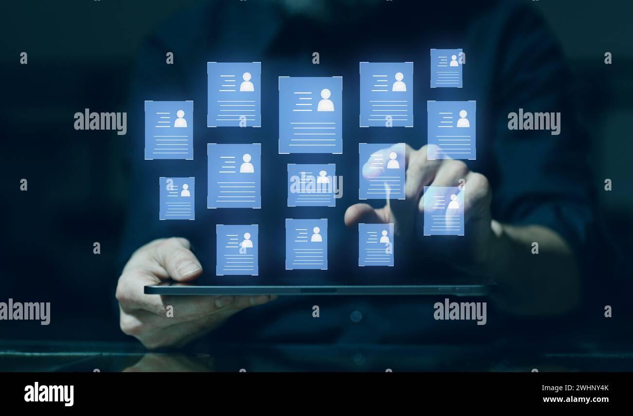Human resources technology concept. HR manager male hands select personnel application form profiles for work on digital tablet. Stock Photo