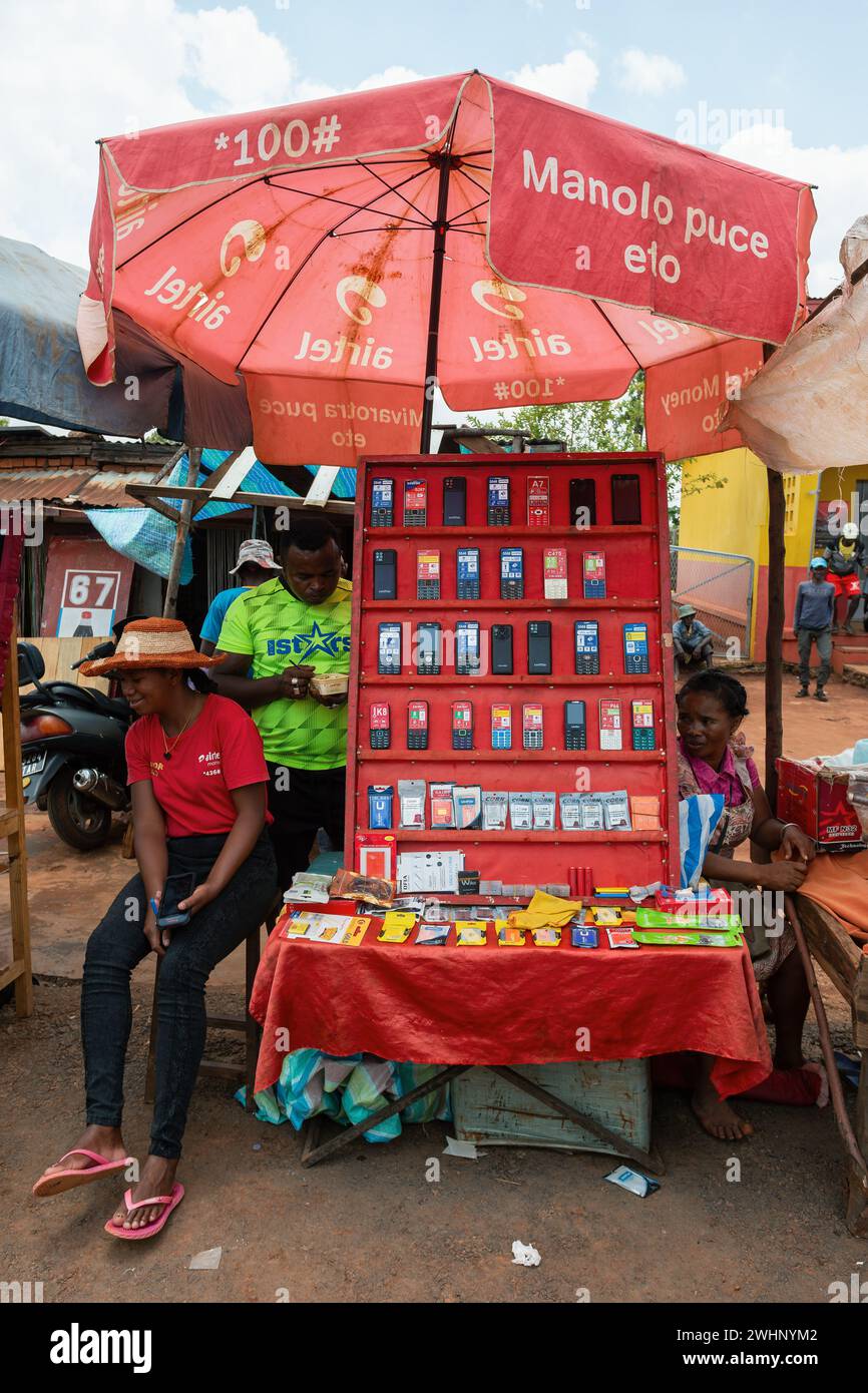 Malagasy woman sell old fashioned cellular mobile phones on the street of Mandoto. Stock Photo