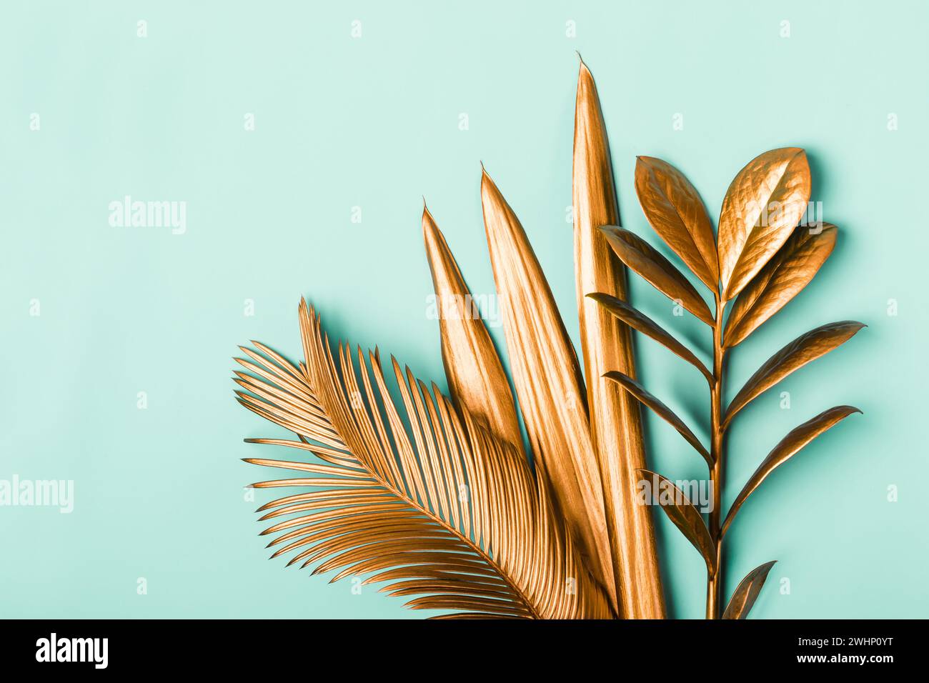 Natural Creative layout made of tropical leaves in golden colors. Minimal surrealism background Stock Photo