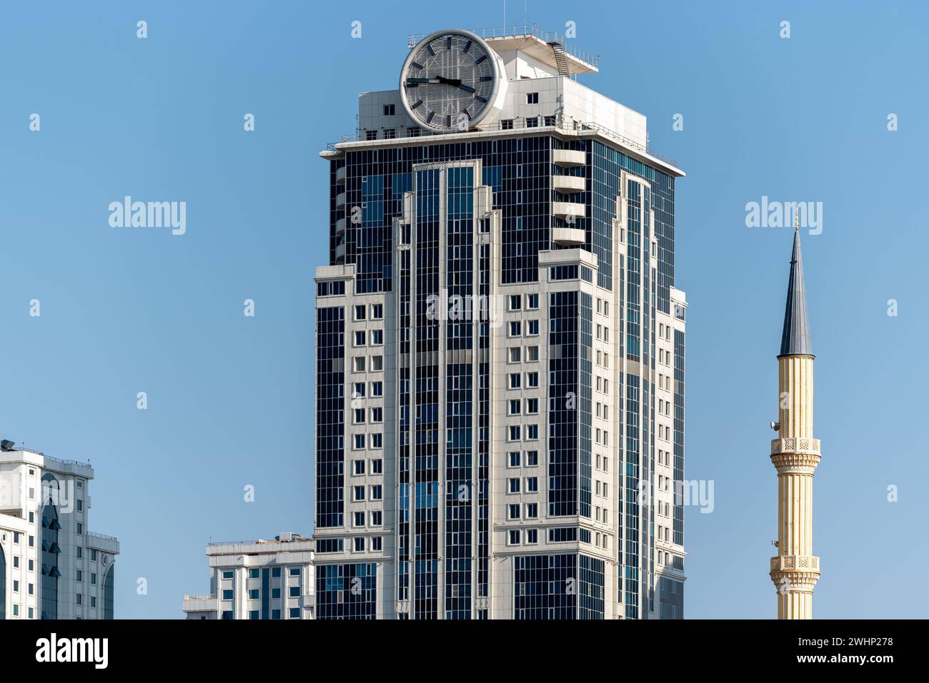 Minaret of traditional Islamic mosque and tall modern skyscrapers in Grozny Chechnya Stock Photo