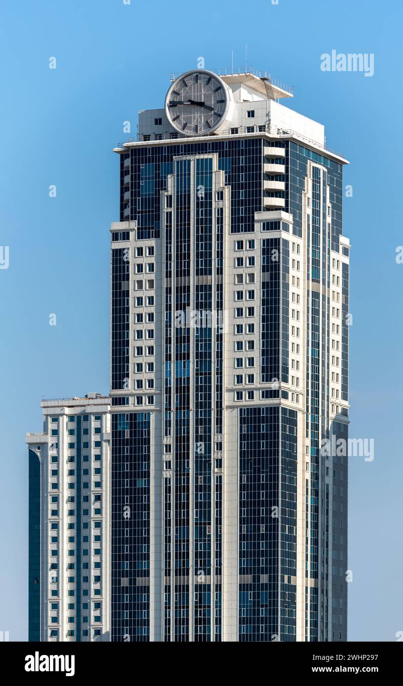 One tall modern skyscraper with a clock in Grozny Chechnya Stock Photo