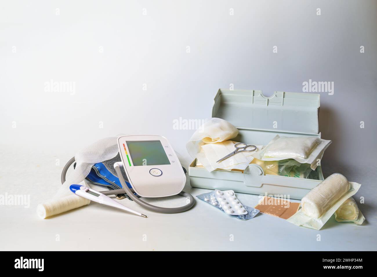 Important medical supplies for first aid and home medicine chest like blood pressure meter, fever thermometer, bandages, plaster Stock Photo