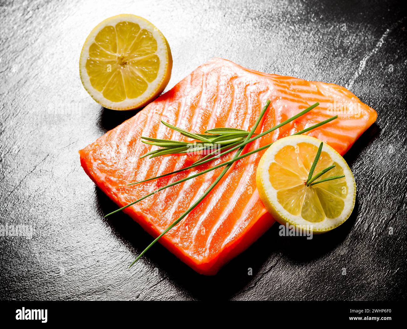 Juicy salmon fillet on black slate plate Stock Photo - Alamy