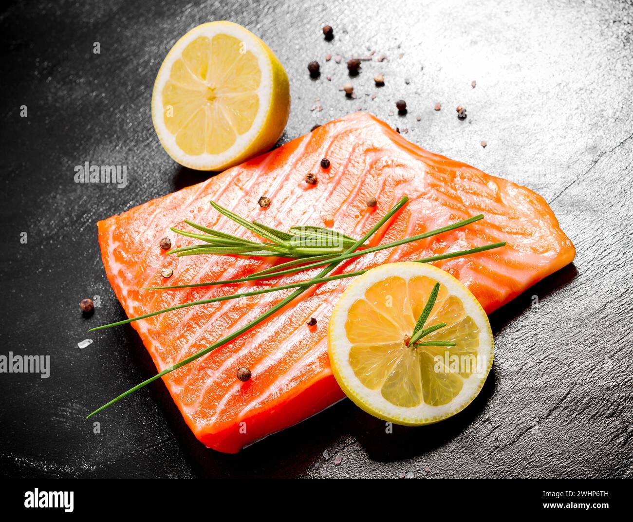 Juicy salmon fillet on black slate plate Stock Photo - Alamy