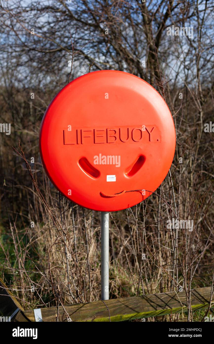 Life saving equipment buoy on a grey post in the park near the Boyne River in Ireland Stock Photo