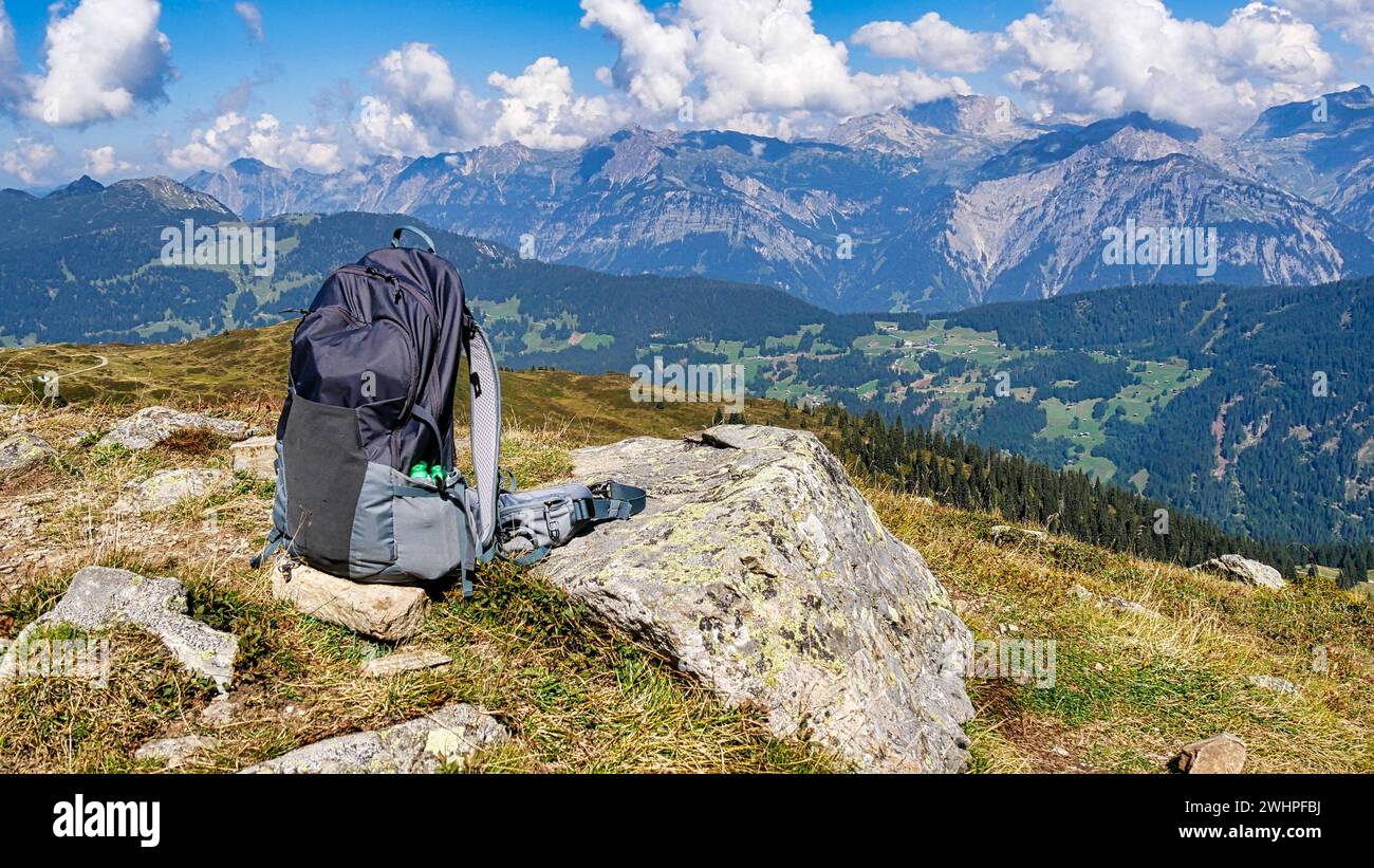 Hiking backpack in front of a beautiful mountain backdrop Stock Photo