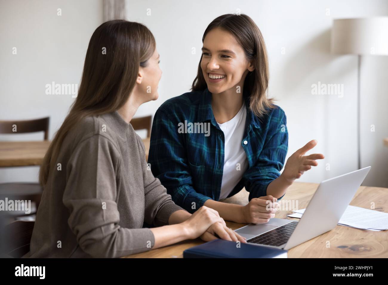 Two cheerful entrepreneurs discussing creative ideas for business project Stock Photo