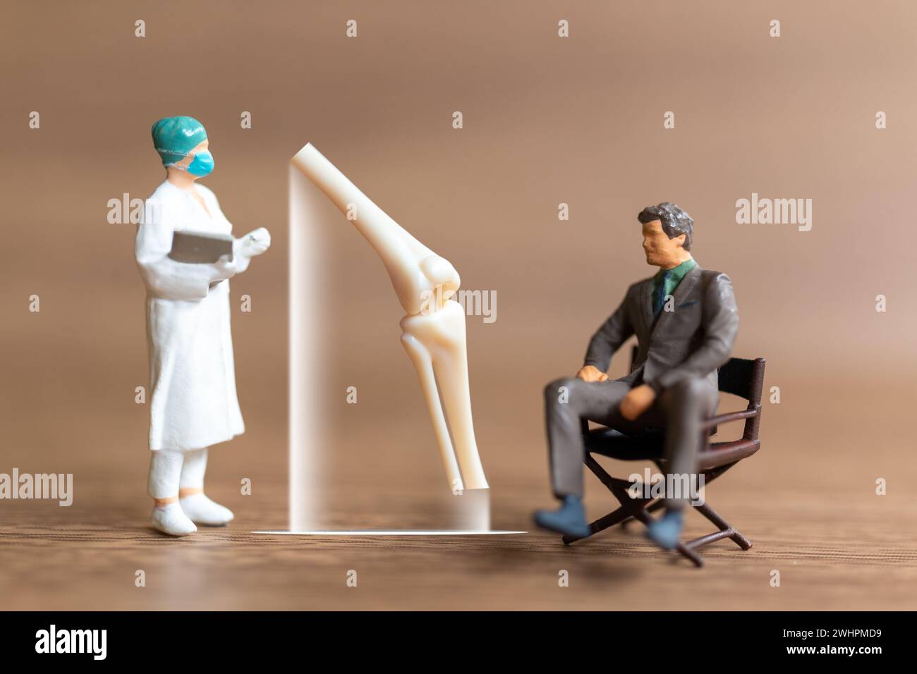 Miniature people patients are discussed  by an orthopedic physician Stock Photo