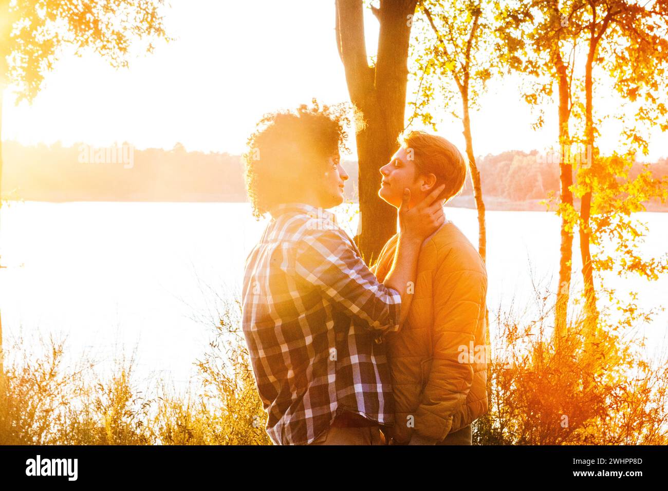Passionate Multiracial Couple Embracing at Sunset, Love Knows No Bounds Stock Photo