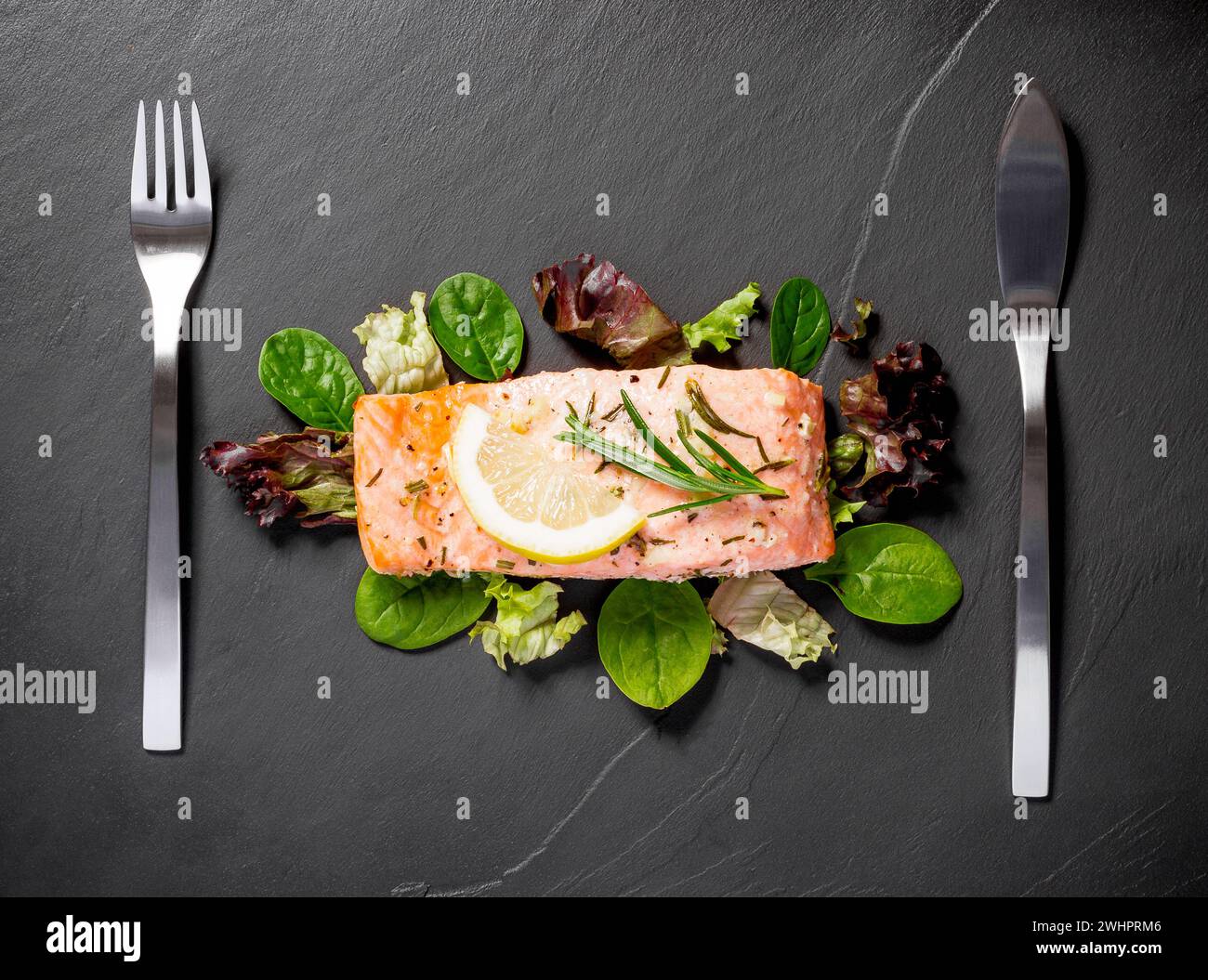 Grilled salmon fillet with salad on black slate plate Stock Photo - Alamy