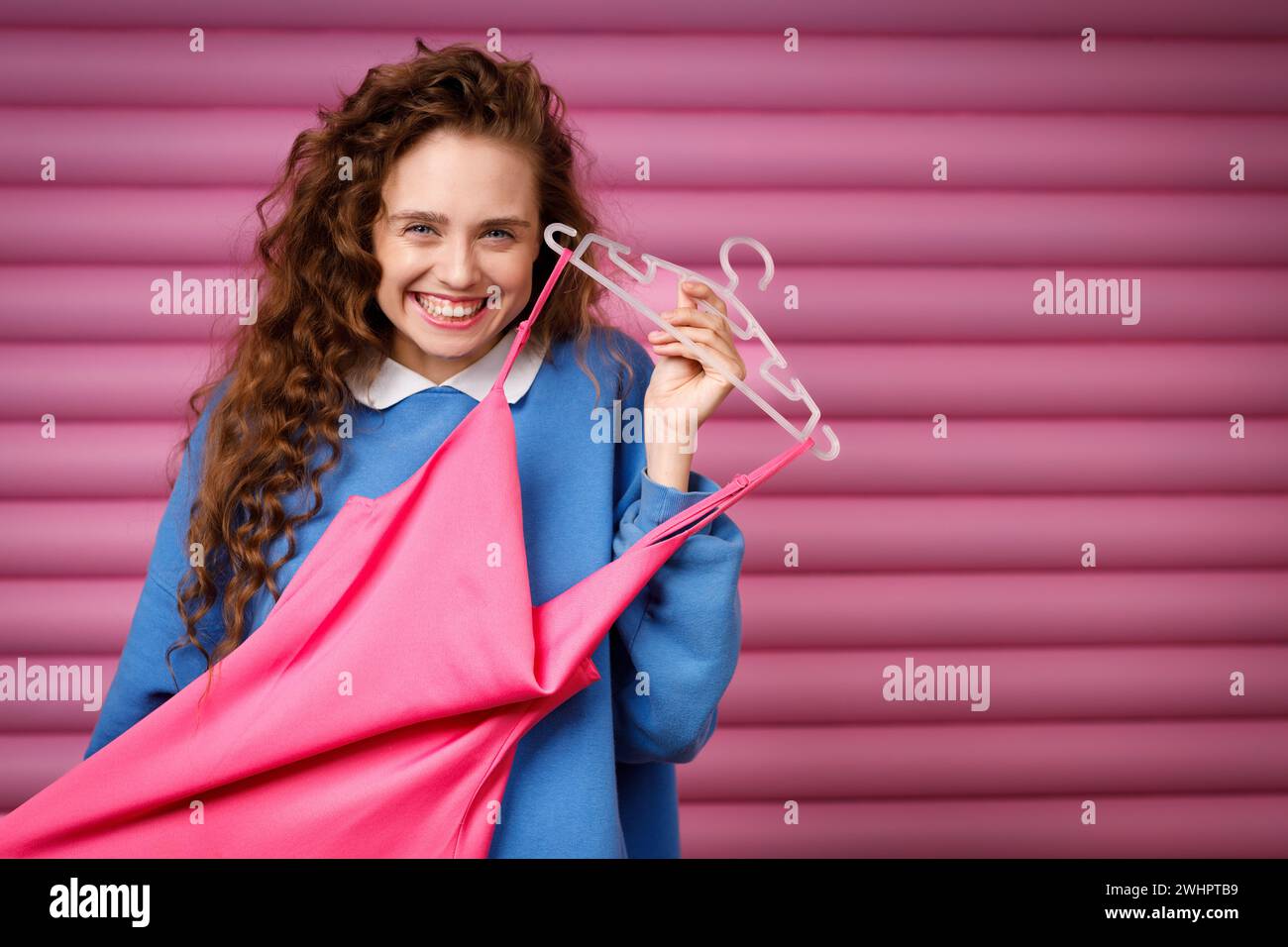 Young woman choosing clothes at fitting room. Shopping concept. Stock Photo