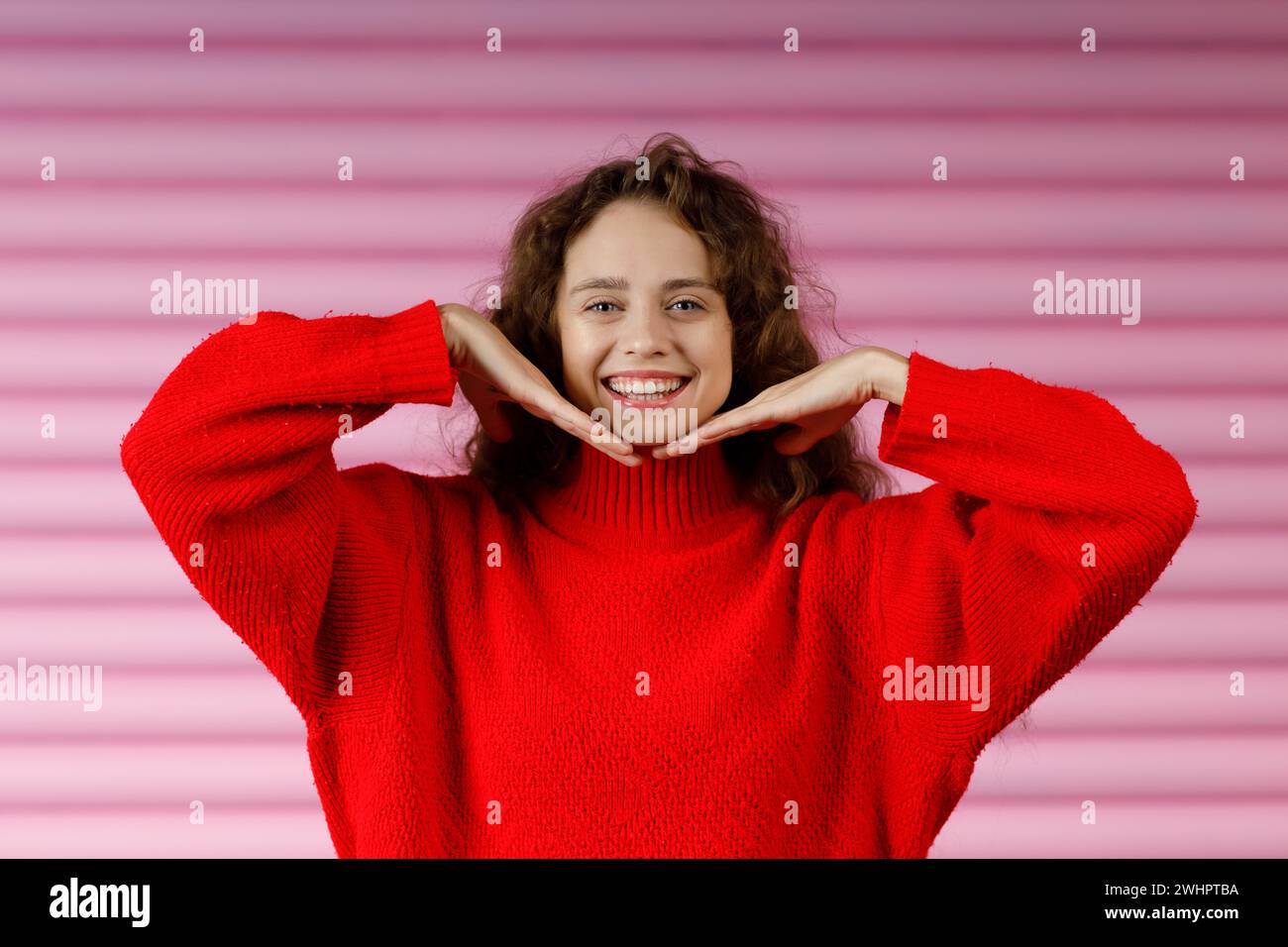 Young red haired woman doing face yoga facial gymnastics self massage