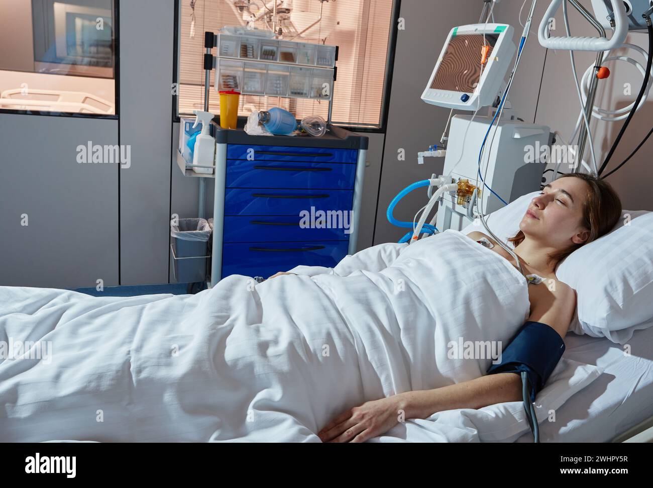 Care of critically ill patient in intensive care unit. Seriously ill woman needs requires intensive treatment and close monitoring Stock Photo