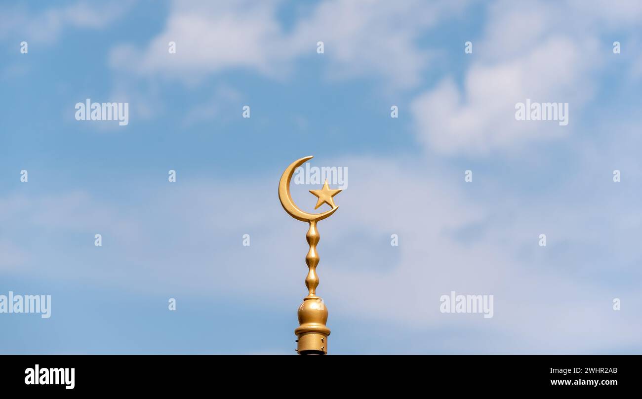 Golden symbol of Islam against blue sky Stock Photo