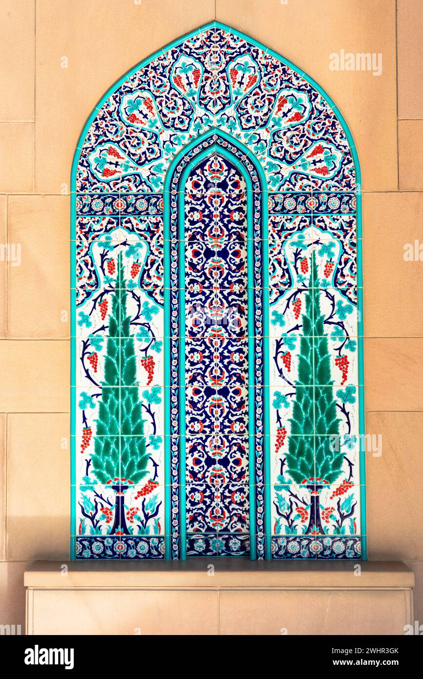 Vivid coloured turquoise traditional arch shaped mosaic on The Sultan Qaboos Grand Mosque interior wall Stock Photo