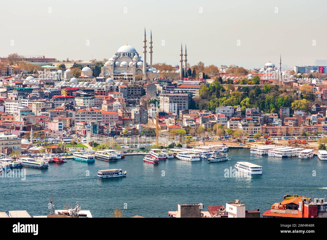 View on Suleymaniye Mosque in the European part of Istanbul, Turkey, Turkiye, panorama in sunny day. Colorful houses with red roofs. Stock Photo