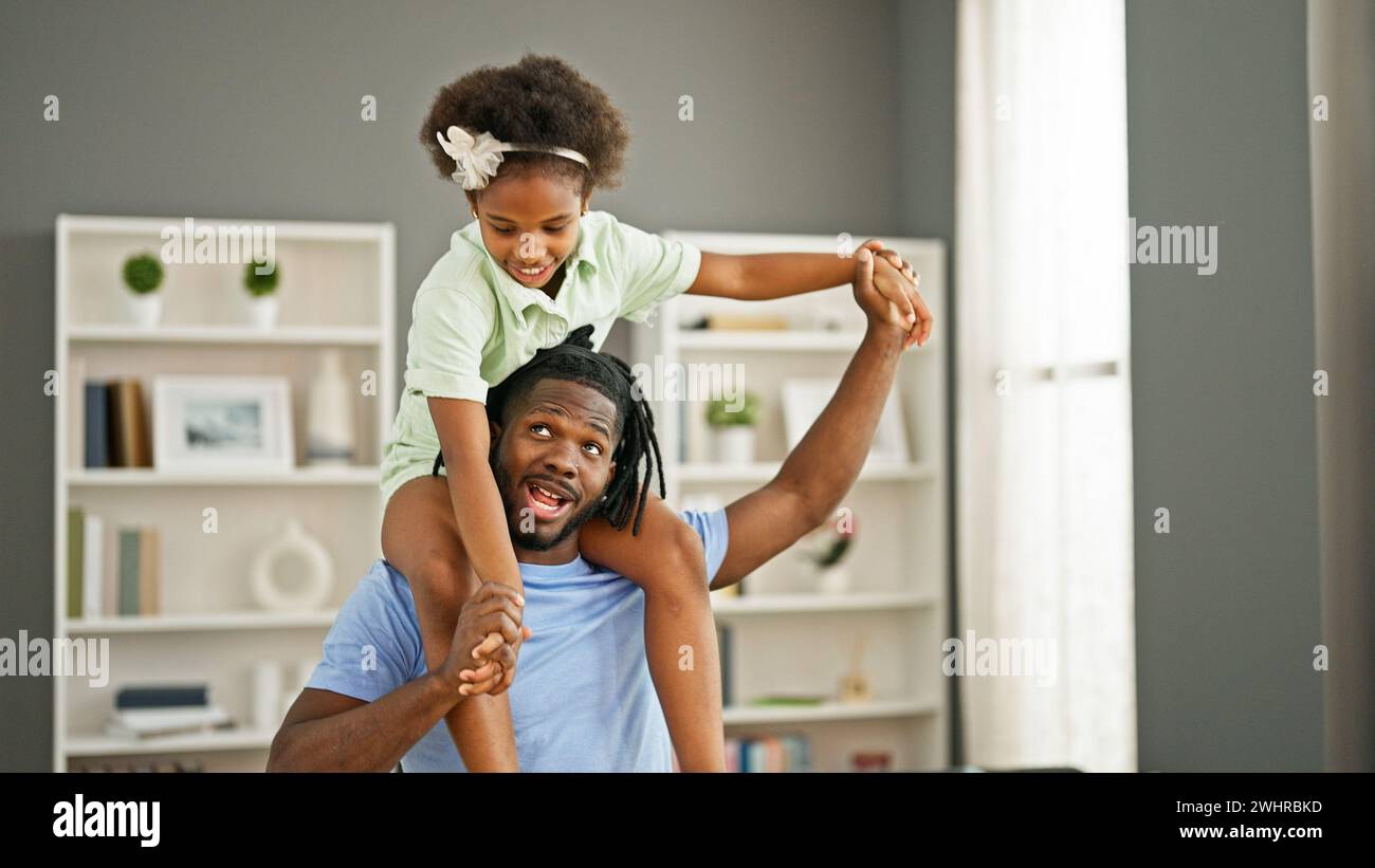 African american father and daughter smiling confident dancing with ...