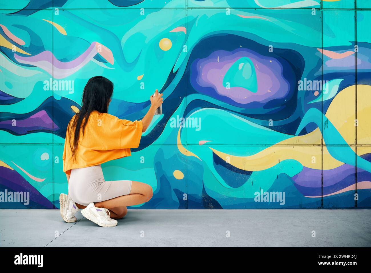 Street artist painting colorful graffiti on wall Stock Photo - Alamy