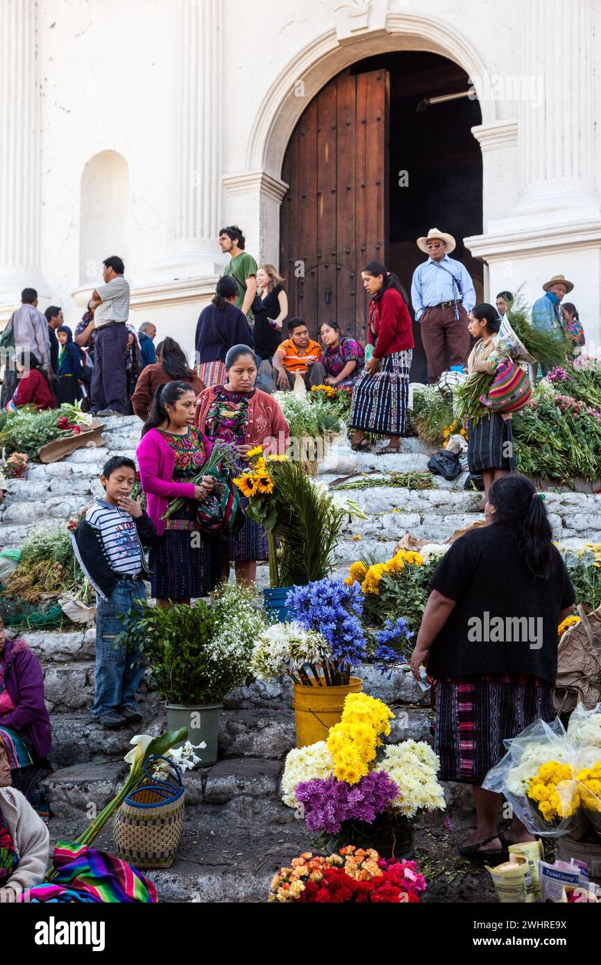 Chichicastenango, Guatemala.  Quiche (Kiche, K'iche') Women Selling Flowers on Steps of Santo Thomas Church on Sunday Morning. Stock Photo