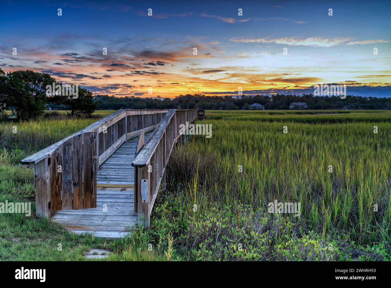 Long wooden dock on the inlet at Pawleys Island in South Carolina at usnset Stock Photo