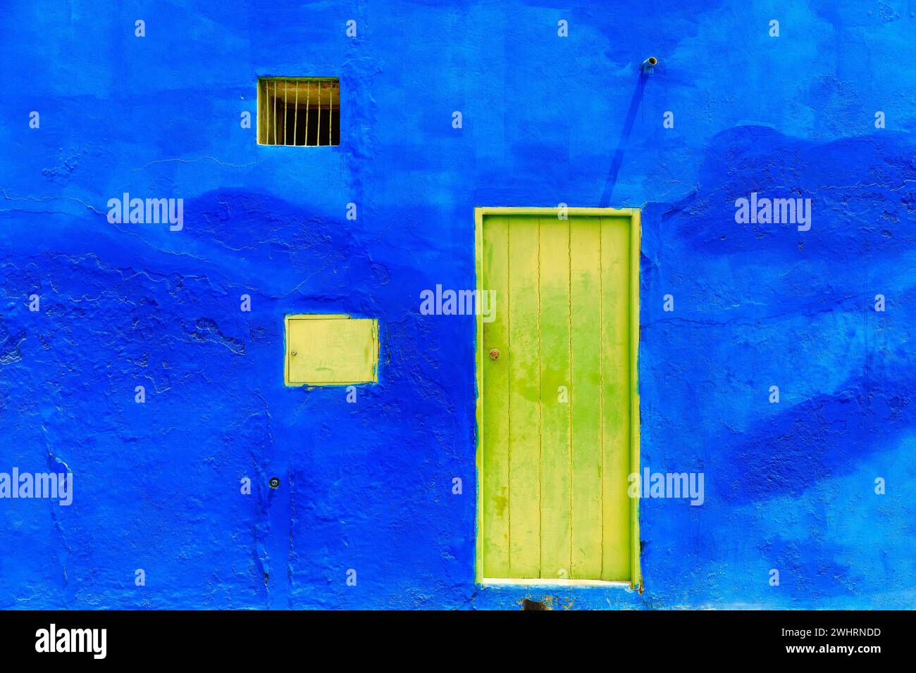 Vivid colors of Boa Vista : the yellow door and blue wall- a colonial color contrast. High quality photo Stock Photo