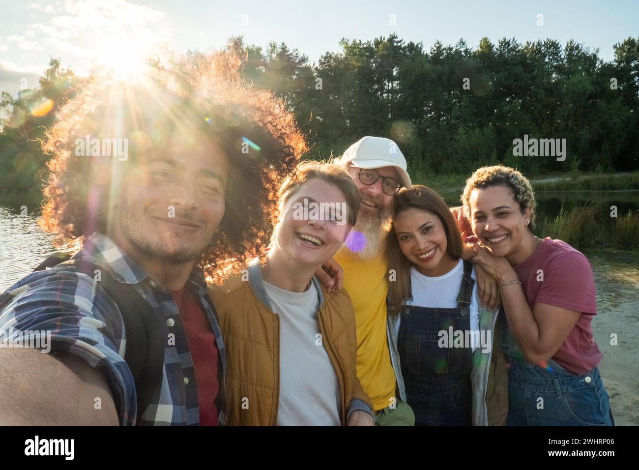 Multiracial young group of trendy people having fun together on vacation - Diverse millennial friends taking selfie portrait tog Stock Photo