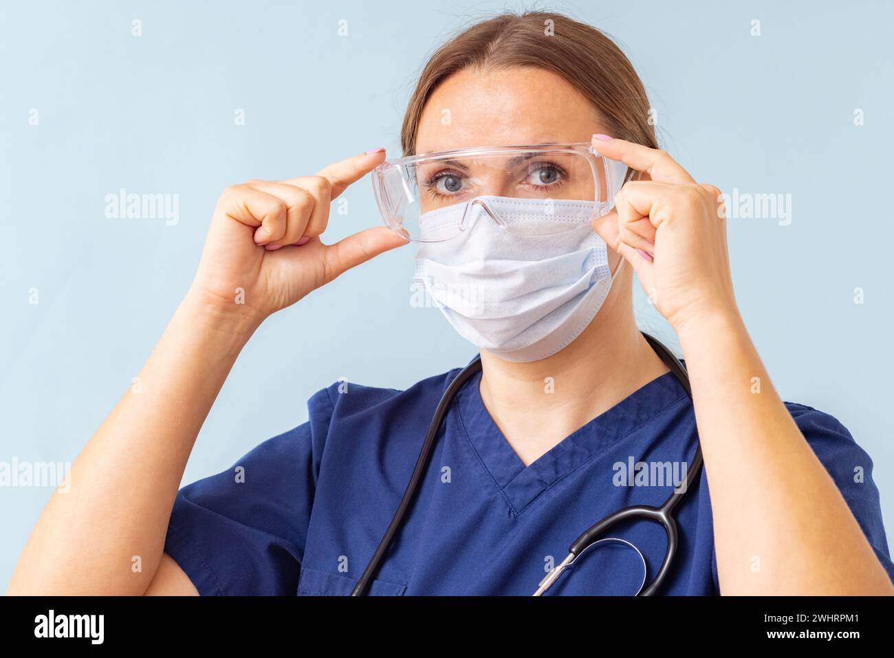 Female Nurse Adjusting Protective Eyewear Stock Photo Alamy