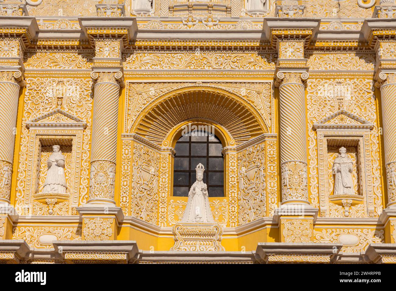 Antigua, Guatemala.  Facade of La Merced Church, completed 1767.  Our Lady of Mercedes in the center, flanked by San Raymundo Nonnatus (left) and Bish Stock Photo