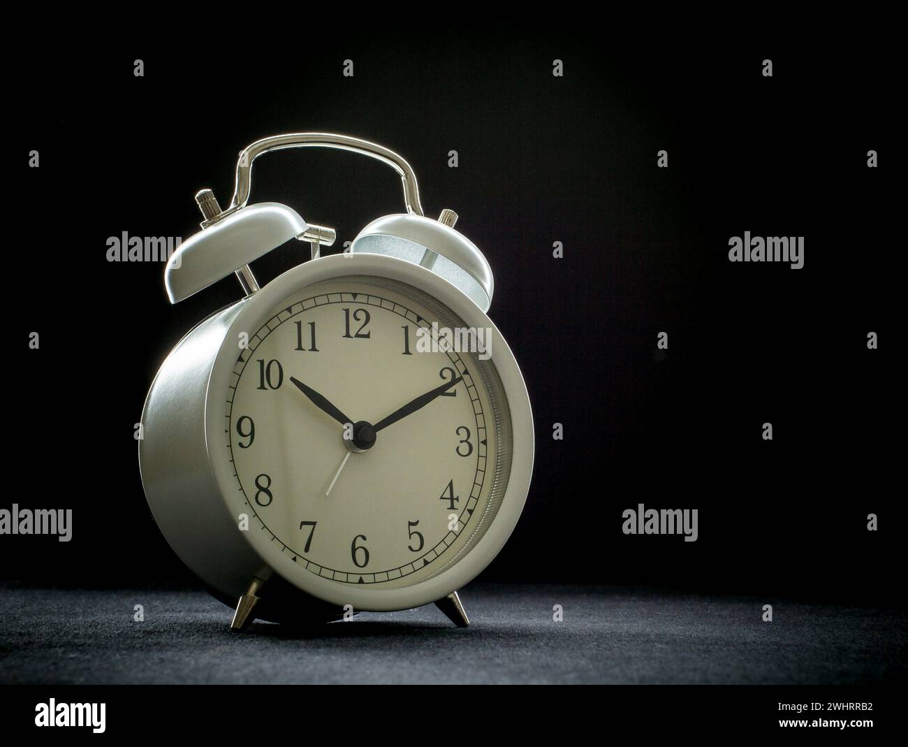 White retro alarm clocks on black Stock Photo