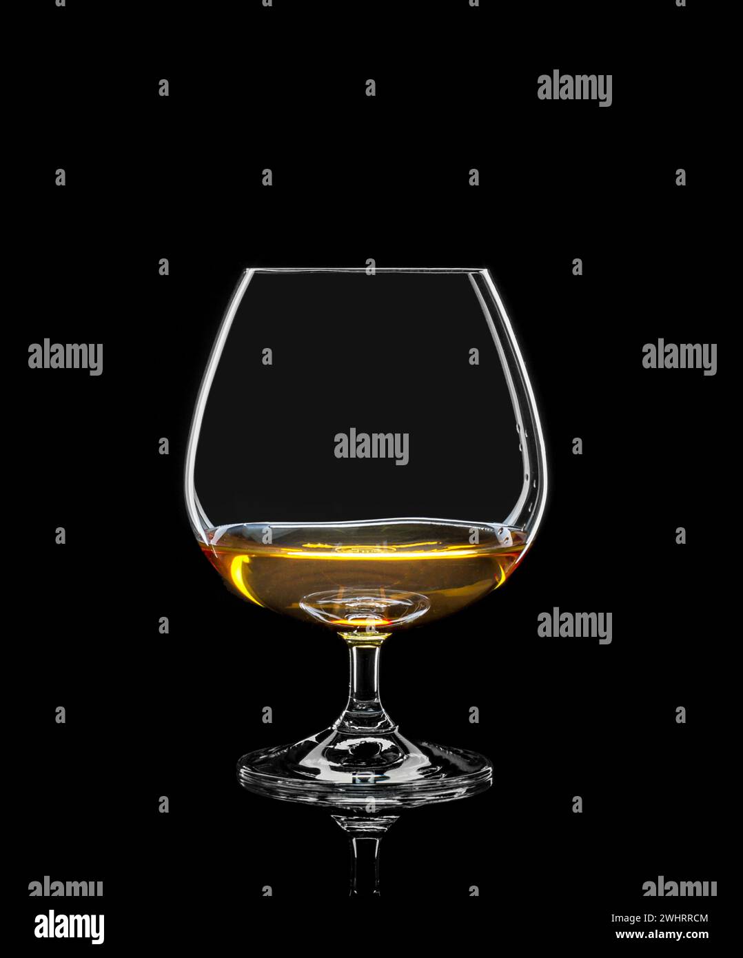 Cognac glass with drink on black Stock Photo Alamy