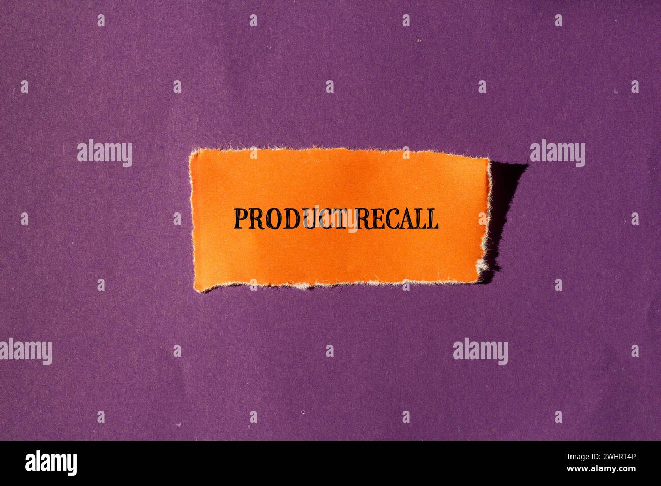 Product recall words written on torn orange paper with purple background. Conceptual business symbol. Copy space. Stock Photo