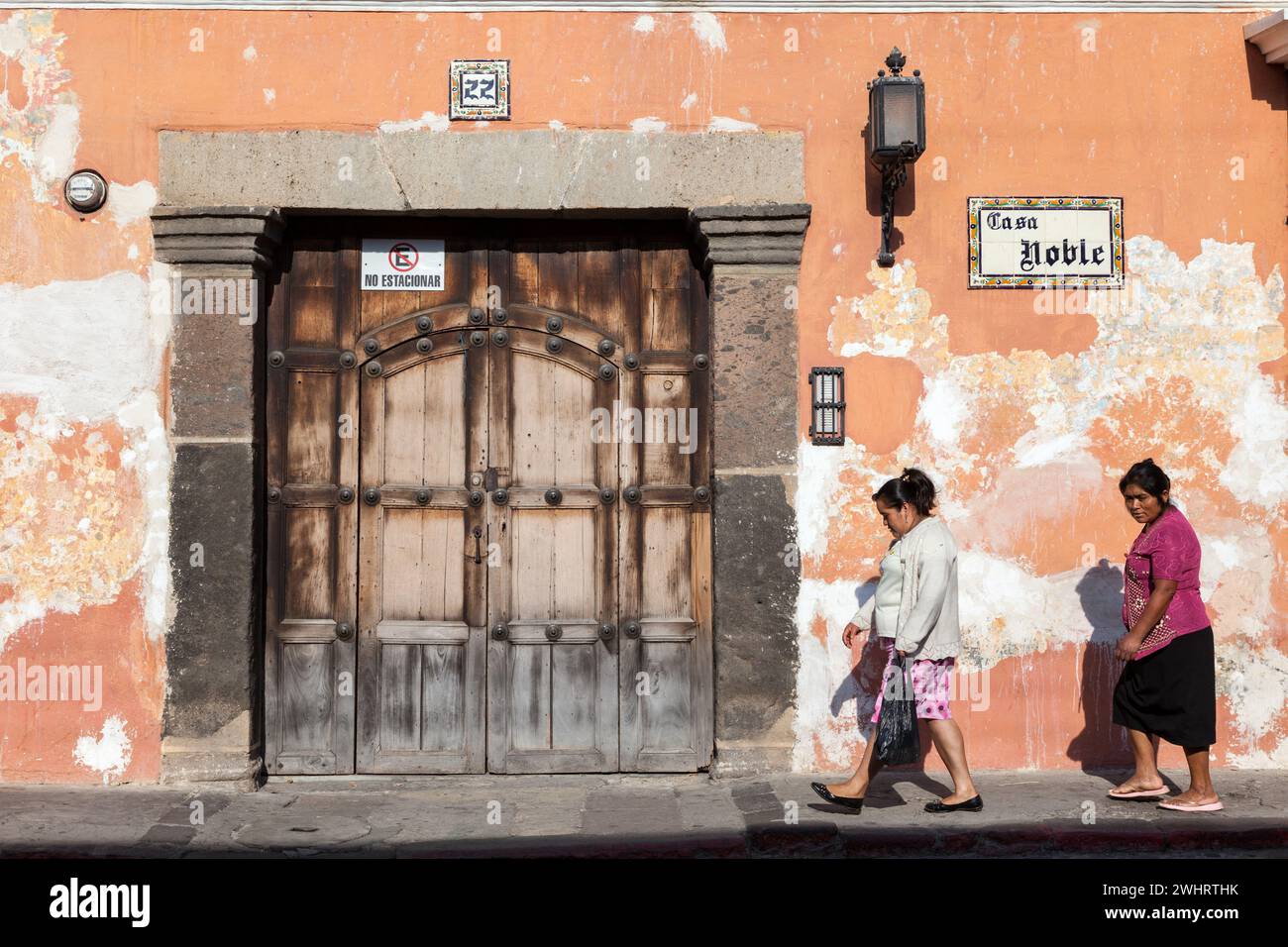 Antigua, Guatemala.  Doorway, Sidewalk, Women Walking. Stock Photo