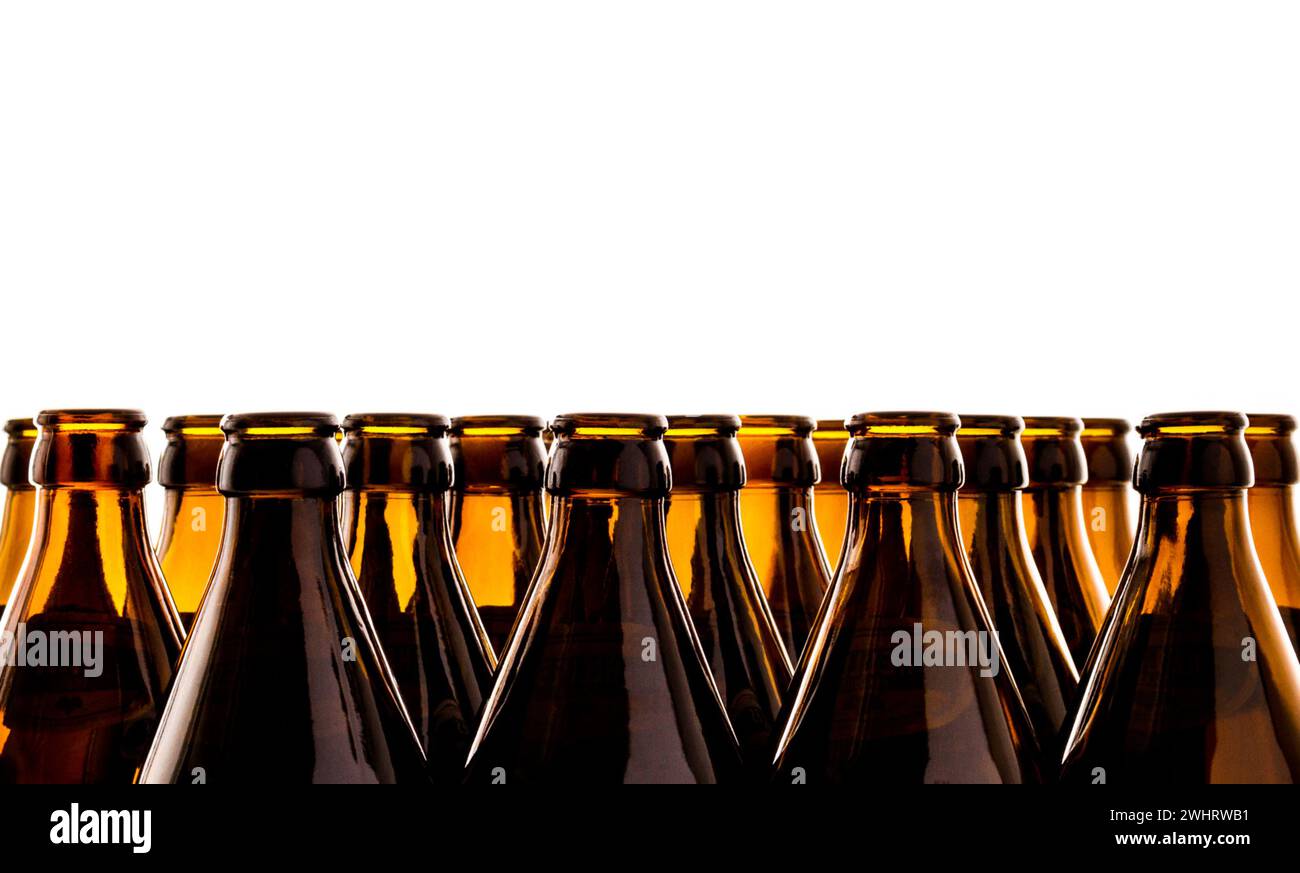 Dozens of empty, brown German beer bottles, isolated as background ...