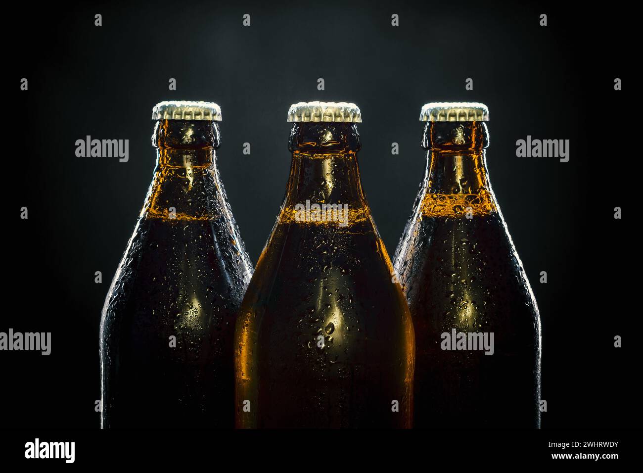 Three cool beer bottles on black Stock Photo