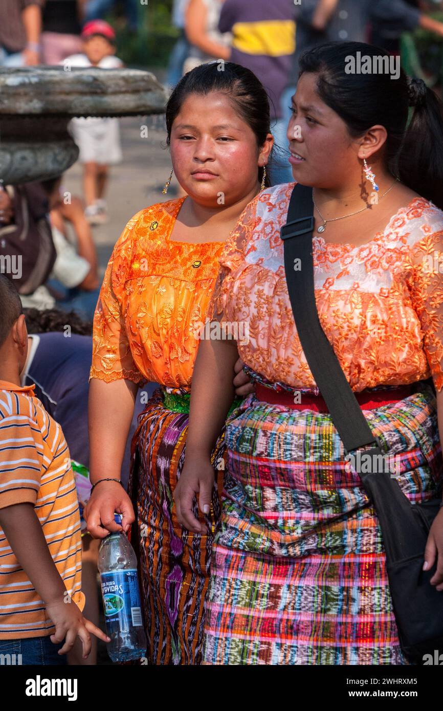 Antigua, Guatemala.  Two Young Maya Women Walking.  Semana Santa. Stock Photo