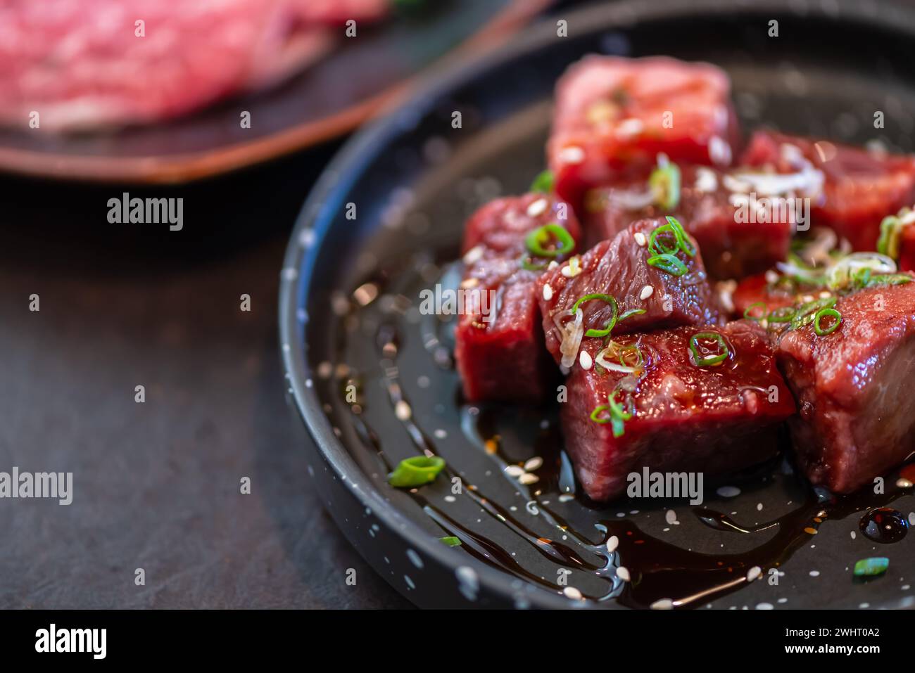 Diced Wagyu beef on dish. Premium Japanese meat concept Stock Photo