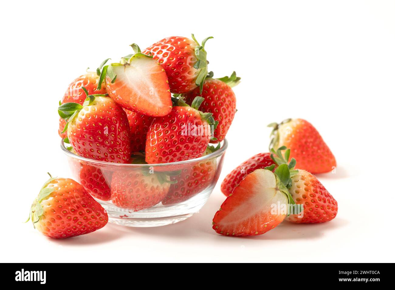 Strawberry on glass isolated on white background. Strawberries with leaf isolate. Whole and half of strawberry on white. Strawberries isolate. Side vi Stock Photo